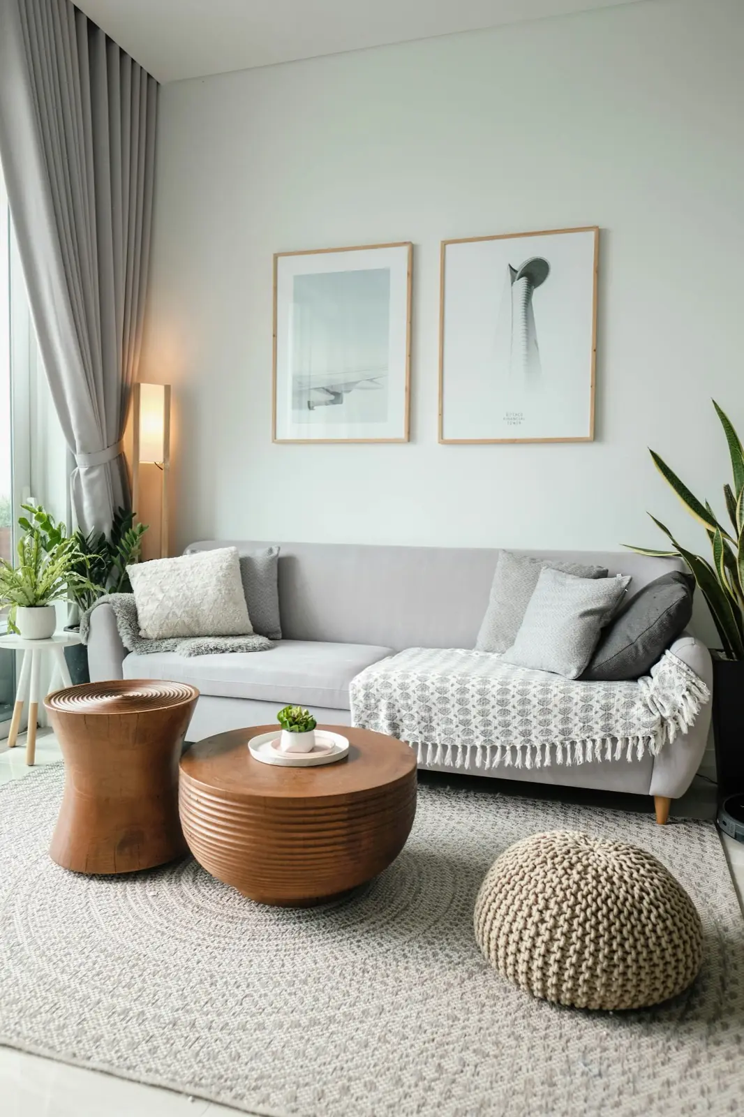 Tidy living room with a gray sofa, a knit throw, and wooden side tables